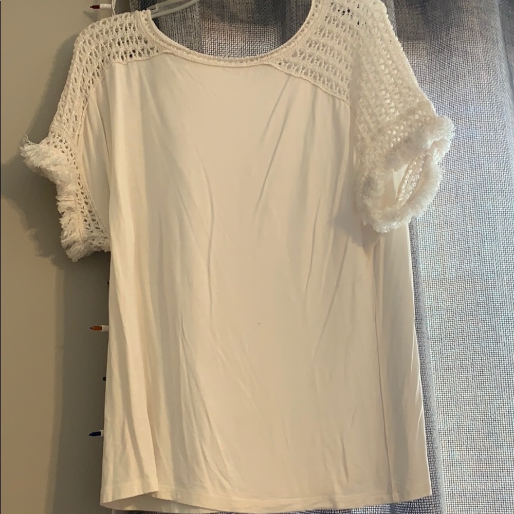 Cream blouse with crochet sleeves.